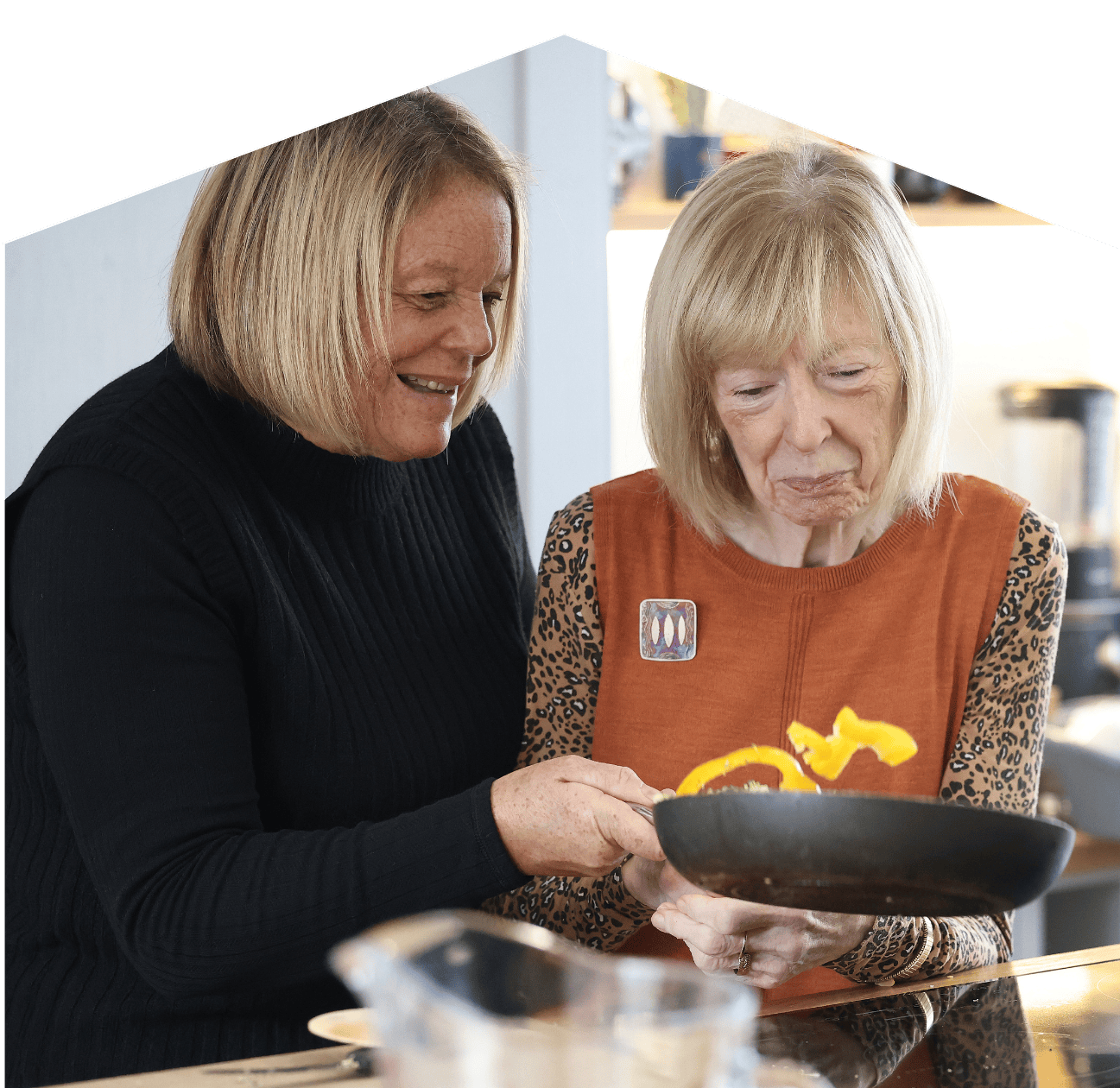 encouraging independence - photo of client and carer cooking in the kitchen